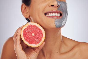 Image showing Skincare, grapefruit and woman with a face mask with charcoal, clay or natural beauty product for wellness, detox or nutrition. Fruit, healthy cosmetics and girl happy with vitman c or facial care