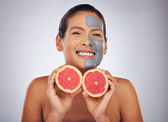 Image showing Woman with grapefruit, skincare and face mask with charcoal, clay or natural beauty product with vitamin c, wellness or detox. Fruit, healthy cosmetics and girl happy with dermatology or facial care