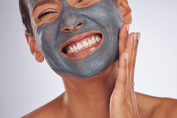 Image showing Happy woman, charcoal mask and face for beauty on studio background. Mature female model smile with clay skincare product, facial cosmetics or aesthetic makeup for dermatology, collagen and self care