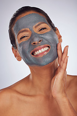 Image showing Happy woman, charcoal mask and portrait for beauty, aesthetic dermatology and self care on studio background. Mature female model touch face with clay skincare product, facial cosmetics and smile