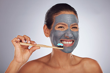 Image showing Woman, brushing teeth and skincare portrait for dental, eco friendly product and charcoal face mask. Beauty, bamboo toothbrush and person or model facial and mouth cleaning on studio white background