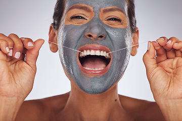 Image showing Portrait, face mask and a woman flossing teeth for skincare, dental hygiene and wellness. Happy, cleaning and a model or girl with gear for tooth cleaning and a facial isolated on a studio background