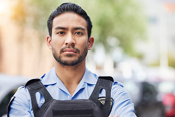 Image showing Portrait, serious police man and security guard for protection service, safety and officer patrol in city. Law enforcement, professional supervision and face of asian crime worker in uniform outdoor