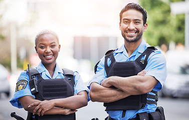 Image showing Happy, portrait and police with arms crossed in the city for security, safety and justice on the street. Team, pride and a black woman and a man with confidence working in urban crime together