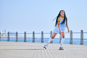 Image showing Skating, portrait and woman with happiness on the promenade for fun and weekend skate. Summer, smile and person with mockup while on roller skates for a trendy activity, hobby and vacation in street