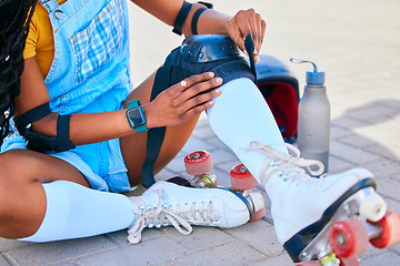 Image showing Sports, city and woman with pads for roller skating for fun activity, learning and training outdoors. Summer, safety gear and female person in street ready to skate, exercise and hobby in urban town