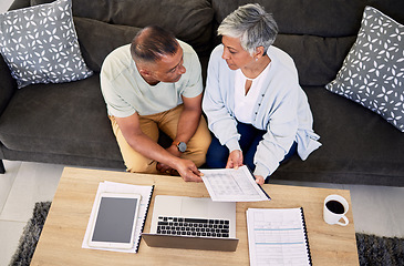 Image showing Senior couple, tax documents and laptop in home living room for discussion, planning and finance. Elderly man, old woman and paperwork for financial compliance in top view, lounge sofa and retirement