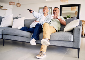 Image showing Senior couple, watching tv and remote on sofa in home living room, laughing and smile for funny comedy show. Elderly man, old woman and relax together for video, comic movie and lounge couch in house