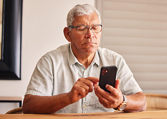 Image showing Phone, social media and a senior man in his home, reading or typing a text message for communication. Mobile, contact and chatting with an elderly male pensioner sitting in his house for networking