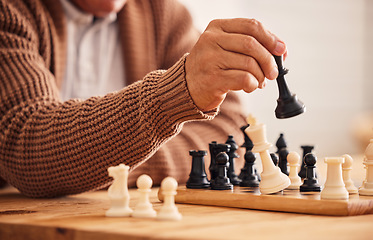 Image showing Man, chess and hand for moving, game or competition with focus, strategy or problem solving at desk. Person, master and brain power for board contest, mindset or checkmate for winning, table or house