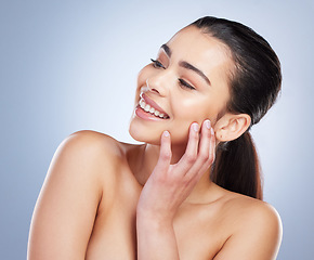 Image showing Happy, thinking and a woman with skincare glow for wellness, beauty or cosmetics. Smile, idea and a young model or girl touching skin for clean feeling and dermatology isolated on a studio background