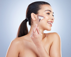 Image showing Makeup, profile and woman with a cosmetic brush in studio for natural, glamour and face routine. Beauty, self care and young female model with a cosmetology facial tool isolated by a gray background.