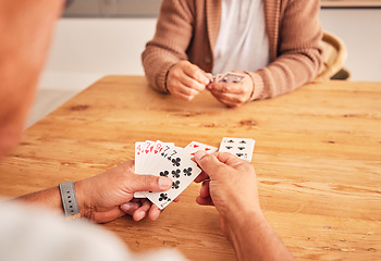 Image showing Hands, cards and a senior man playing a game at a table in the living room of a retirement home. Thinking, planning and fun with an elderly male pensioner in a house closeup for entertainment