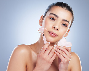 Image showing Beauty, facial roller and skin portrait of a woman in studio with skincare tools for natural glow. Face of a female aesthetic model on a gradient background for shine, cosmetics and self care massage