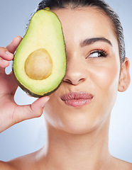 Image showing Avocado, skincare and face of woman in studio with doubt of natural detox, wellness or omega 3 treatment on white background. Fruit, diet or lady model unsure of anti aging or vitamin c facial beauty