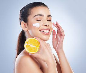 Image showing Lemon, skincare and asian woman with face cream in studio for wellness or cosmetic mask on grey background. Citrus, fruit and lady with facial for dark spots, melasma or acne prevention or sunscreen