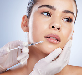 Image showing Syringe, woman and plastic surgery with skincare, collagen and beauty against a studio background. Female person, girl or model with a needle, cosmetics or body transformation with aesthetic and care