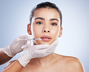 Image showing Syringe, woman and plastic surgery with skincare, portrait and cosmetics against a studio background. Female person, girl and model with a needle, face detox or body transformation with aesthetic