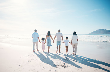 Image showing Travel, beach and family walking on sand together at the sea or ocean bonding for love, care and happiness. Happy, sun and parents with children or kids and grandparents on a holiday for freedom