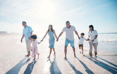 Image showing Water, beach and big family together on holiday at the sea or ocean bonding for love, care and happiness. Happy, sun and parents with children or kids and grandparents on a vacation for freedom