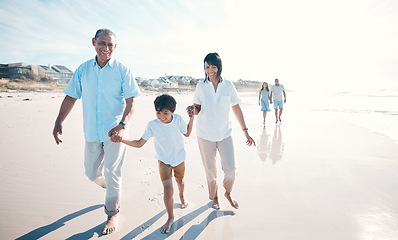 Image showing Vacation, beach and grandparents walking child together at the sea or ocean bonding for love, care and happiness. Happy, sun and elderly people with kid on a summer travel holiday for freedom