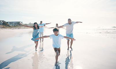 Image showing Fly, beach and happy family running or playing together at the sea or ocean bonding for love, care and happiness. Summer, sun and parents with children or kids and grandparents on holiday for freedom