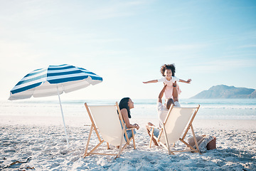 Image showing Happy, love and portrait of a family at the beach for playing, bonding and holiday at the ocean. Smile, summer and a child with freedom and playful father with a mother at the sea for a vacation