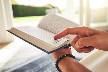 Image showing Reading book, muslim or hands of person with Quran on Eid Mubarak praying to God or worship at home. Allah, hope or Ramadan with spiritual man learning Islamic info for faith, religion and gratitude