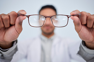 Image showing Hands, man and optician with glasses for vision, eyesight and eye care prescription lens. Closeup of doctor, optometrist and frame for eyewear, test and consulting for optical assessment in clinic