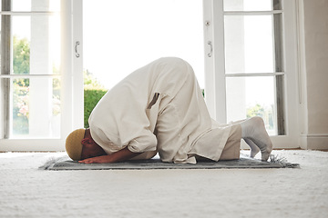 Image showing Prayer, muslim and islamic with man on living room floor for eid mubarak, God and worship. Quran, hope and Ramadan with spiritual person praying on mat at home for faith, religion and gratitude