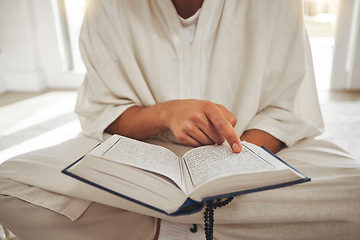 Image showing Reading book, muslim or hands of man with Quran on Eid Mubarak praying to God or worship at home. Allah, hope or Ramadan with spiritual person learning Islamic info for faith, religion and gratitude