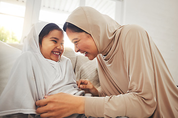 Image showing Laughing, play and muslim grandmother, happy child or family bond, enjoy quality time together and granny tickle girl. Lounge sofa, funny or Islamic grandma, youth kid or playing people laugh at home