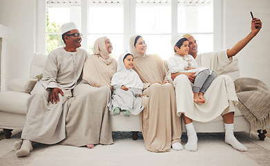 Image showing Selfie, Islam and big family on sofa with smile, grandparents and parents with kids in Arab home. Portrait of Muslim men, women in hijab and happy children, generations in sitting on couch together.