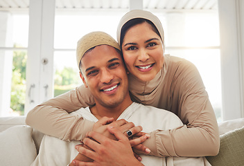 Image showing Portrait, Islam and happy couple hug on couch with smile, culture and love in home in Turkey. Face of Muslim man, woman in hijab and happiness in marriage on sofa, together in respect and religion.