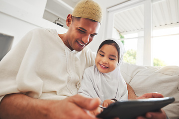 Image showing Family, tablet or education with a father and muslim girl on a sofa in the living room of their home together for e learning. Kids, study or child development with a man teaching his student daughter