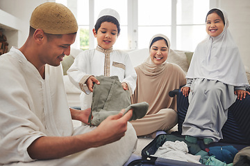 Image showing Eid, packing and a Muslim family in a house for a holiday, or vacation preparation together. Happy, talking and Islamic parents with young children and a suitcase for clothes, travel or hajj