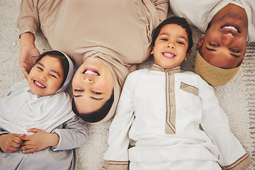 Image showing Portrait smile, floor and muslim family of mother, father and children smile, love or enjoy quality time together. Lounge top view, care and happy face of Islamic mom, young kids or dad relax at home