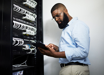 Image showing Data center, tablet and serious technician man with cables for internet connection for software programming. Engineer black person with tech for cybersecurity, wire or problem solving in server room