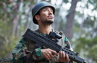 Image showing Soldier, army and man thinking with gun in forest training, outdoor shooting or military exercise, mission and focus. Rifle, veteran and young person search woods or nature in battlefield gear vision