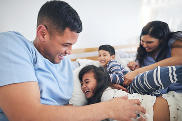 Image showing Family, tickle and play on bed with fun and smile in a home with bonding and parent care. Happy, house and bedroom with a father, mom and children together in the morning with dad, mother and kid