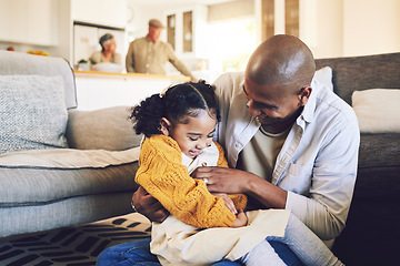 Image showing Family, happy and father with girl child on a living room floor playing, laugh and bond in their home together. Love, hug and kid with parent in a lounge for tickle, fun and games on the weekend