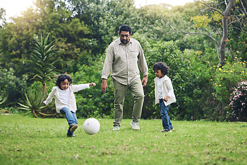 Image showing Happy, soccer and father with children in garden for playful, learning and sports. Summer, fitness and family with man and kids playing football in backyard at home for teaching, workout and growth