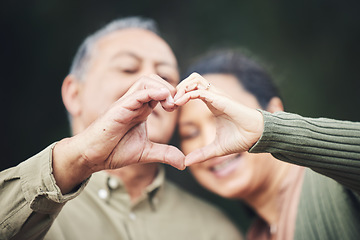 Image showing Heart, hands and a senior couple in a house for love, care and showing an emoji together. Happy, trust and an elderly man and woman with a gesture for romance, marriage or valentines day with bokeh