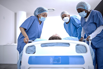 Image showing Covid, surgery and doctors with a patient for a check, healthcare support and consultation. Hospital, medical and surgeons or nurses helping a sick patient in a bed with face mask for nursing