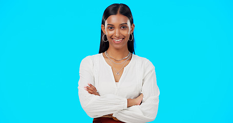 Image showing Face, proud and business woman in studio, happy and empowered against blue background space. Portrait, leader and indian lady entrepreneur motivated for startup, goal or career while posing in power