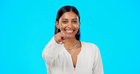 Image showing Face, motivation and Indian woman pointing to you, promotion and happiness against a blue studio background. Portrait, female and lady with inspiration, choice and decision with selection and choice