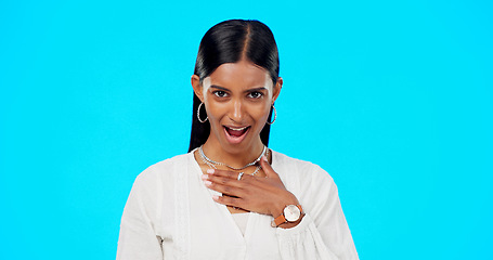 Image showing Shocked, surprised and woman portrait of wow face in studio on a blue background for announcement or news. Indian female model with hand on chest for attitude, compliment or emoji for gossip or rumou