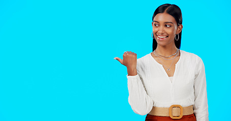 Image showing Business woman, pointing and face of a Indian female in a studio gesture to mockup for advertisement. Idea, happiness and smile of a corporate employee point thumb to show mock up advertising