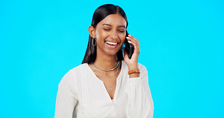 Image showing Happy phone call, business woman and studio with a Indian female talking and speaking. Mobile communication, online discussion and networking of a young person smile with isolated blue background