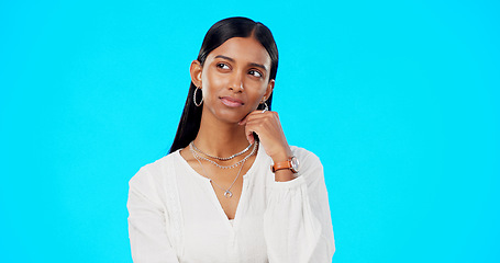 Image showing Thinking, confused and ideas of woman isolated on blue background university choice, college or scholarship decision. Indian person contemplating, thoughtful and serious inspiration in studio mockup